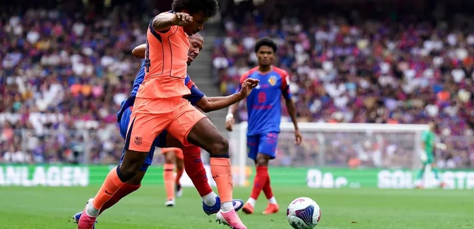 Player challenging for the ball during football match