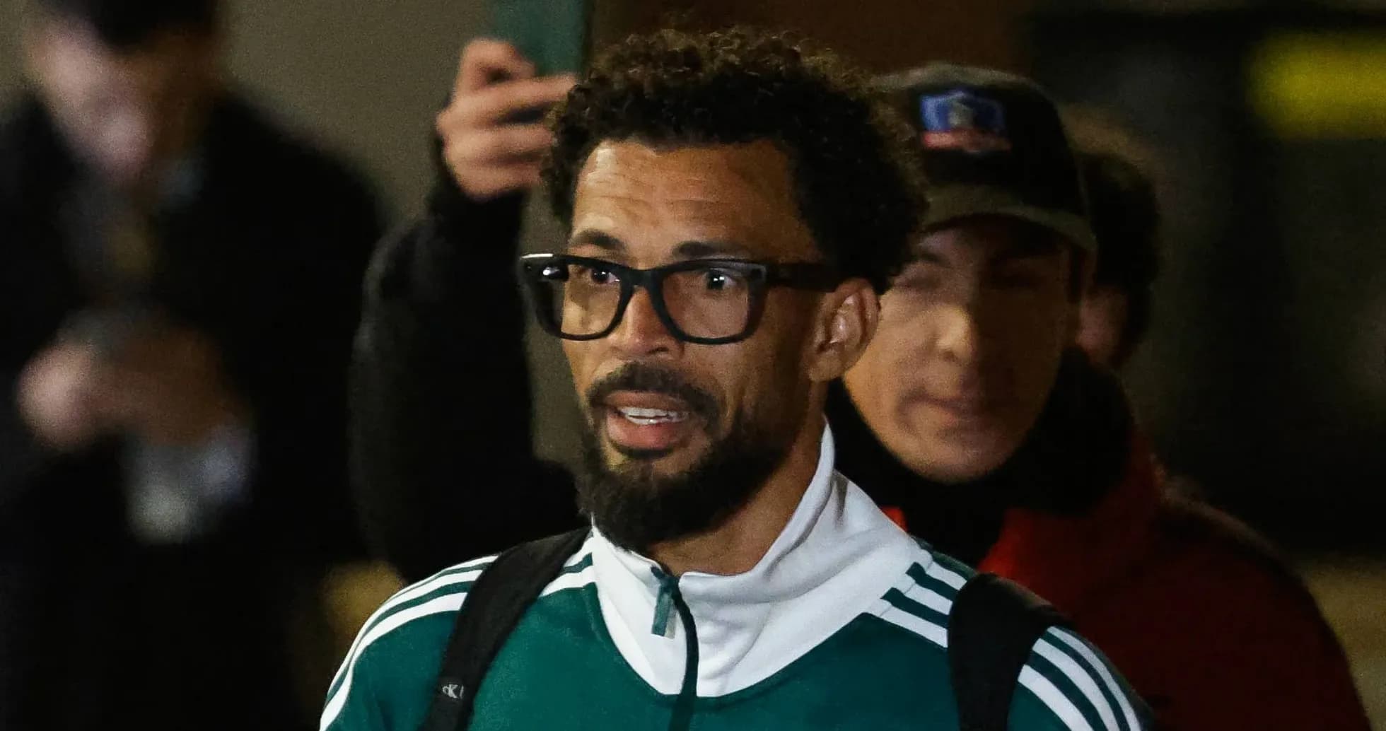 Player arriving in team tracksuit with glasses