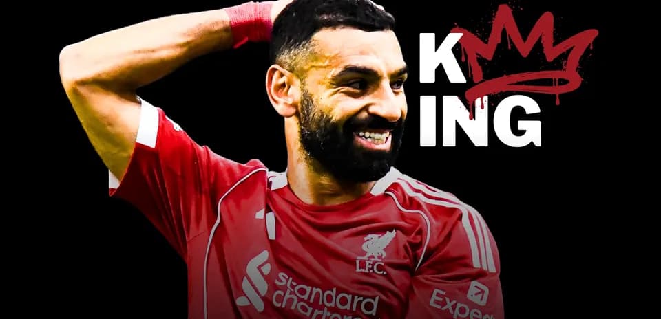 Player celebrating in Liverpool jersey with crown graphic