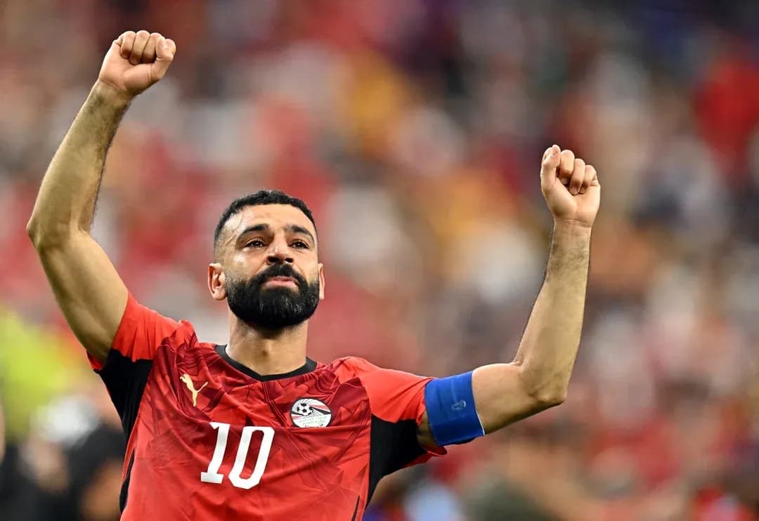 Player celebrating with raised arms in Egypt kit