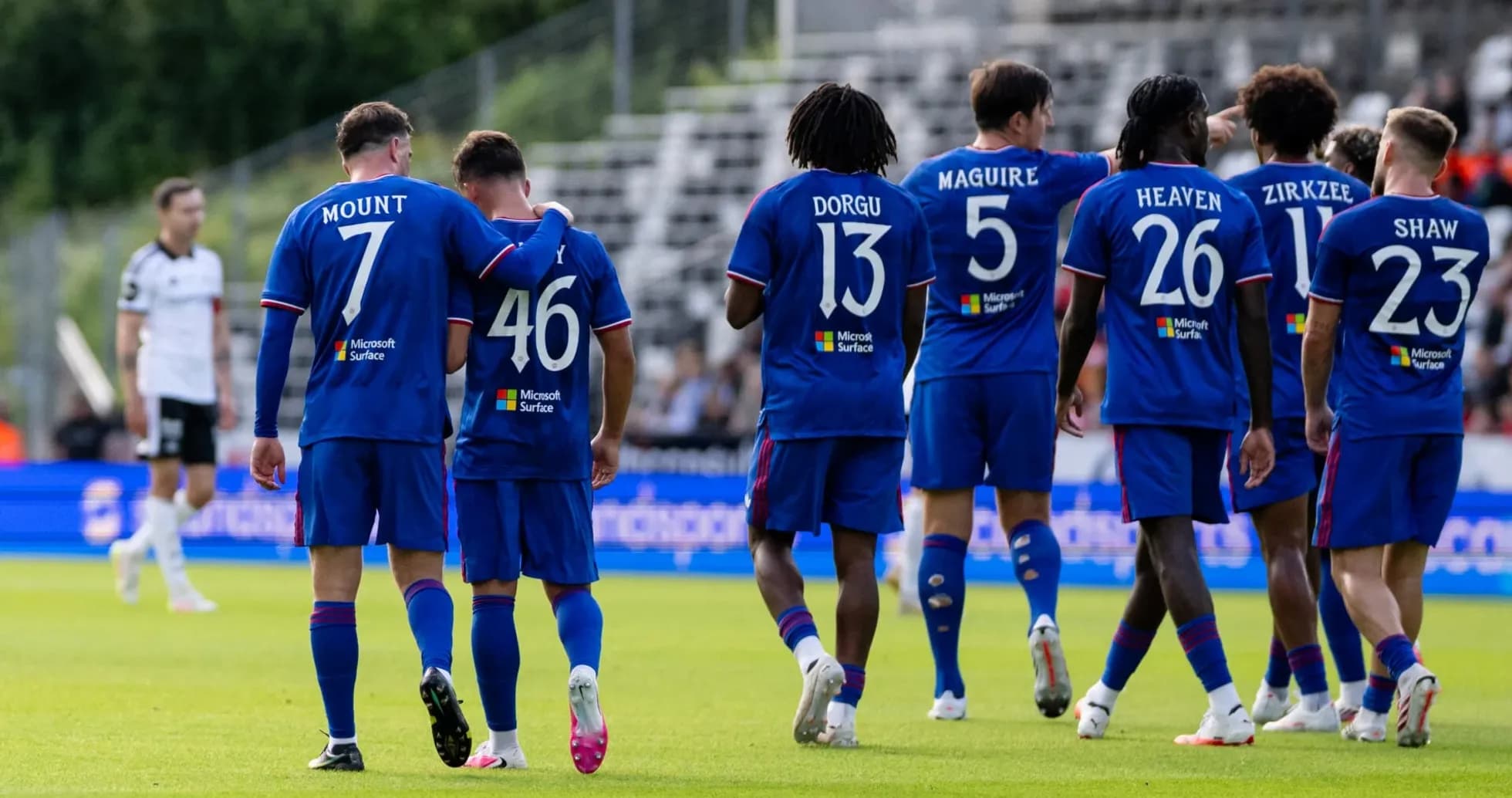 Players in blue jerseys celebrating on the pitch