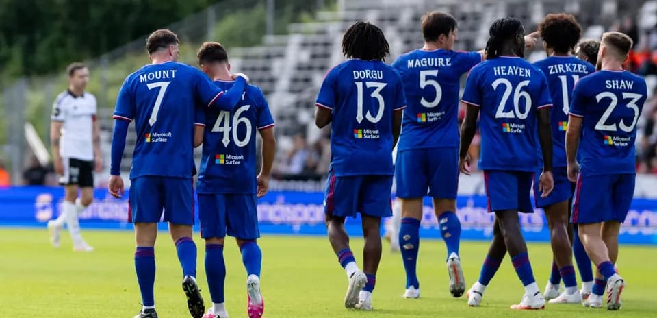 Players in blue jerseys celebrating on the pitch