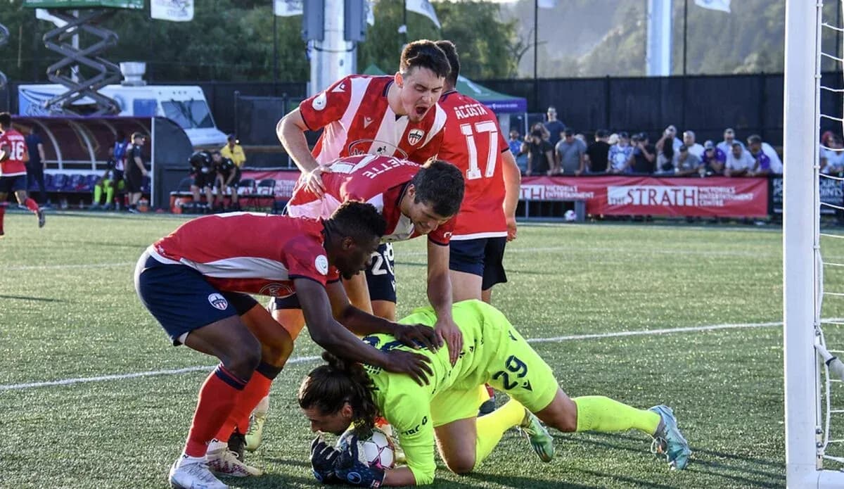 Players from Atlético Ottawa and Pacific FC in action