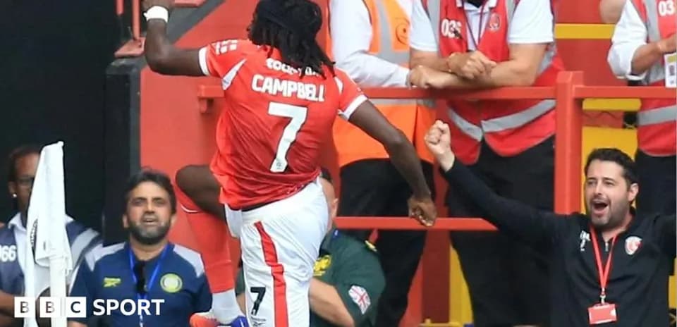 Player celebrating with fans after scoring a goal