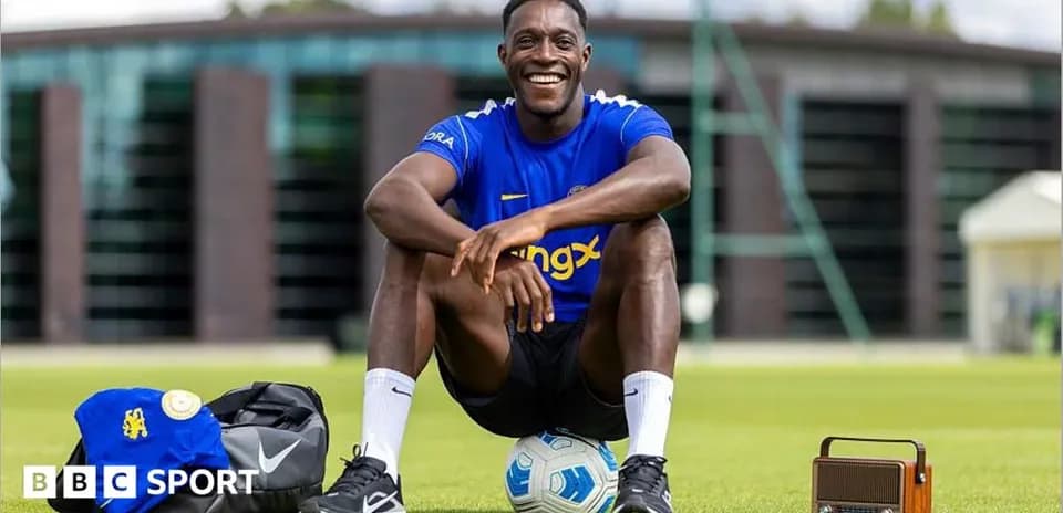 Player smiling while sitting on training pitch