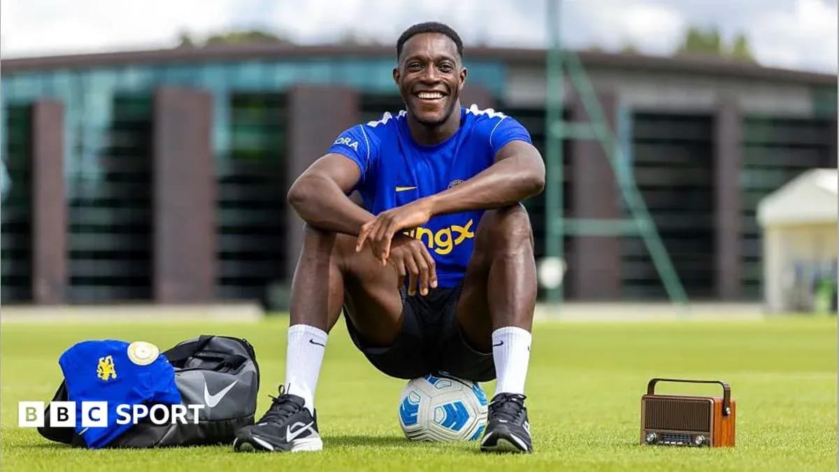 Player smiling while sitting on training pitch