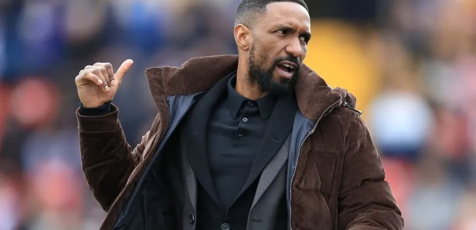 Coach gesturing on the sidelines during match
