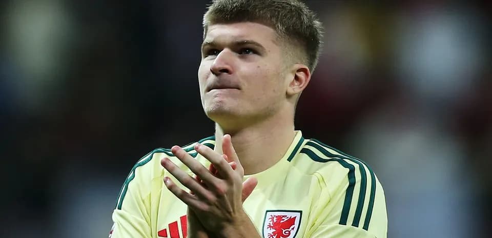 Player in yellow jersey applauding fans after match