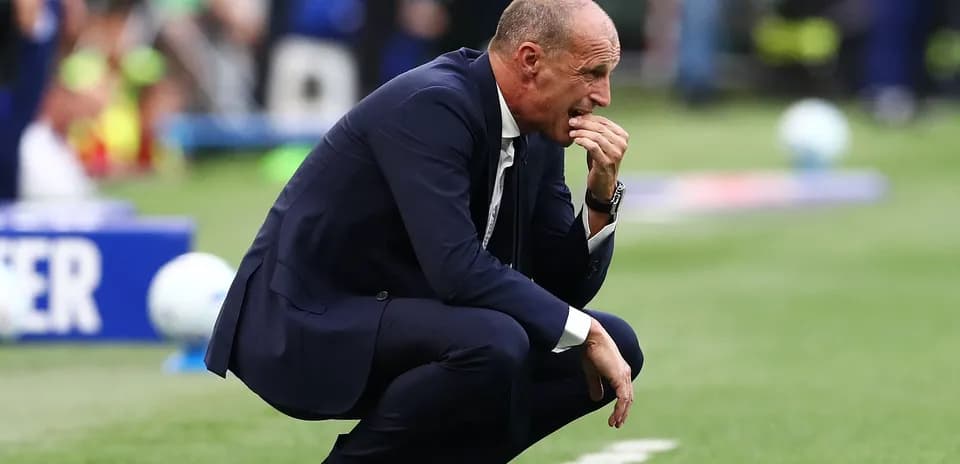 Coach crouching on sidelines during a match