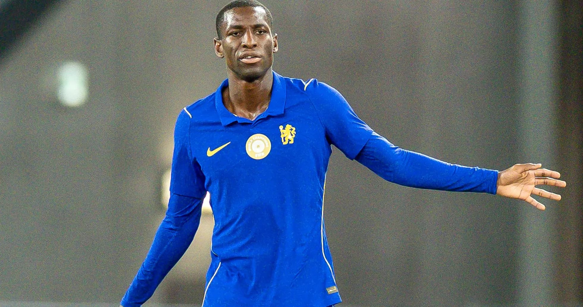 Player in blue kit gesturing during training session