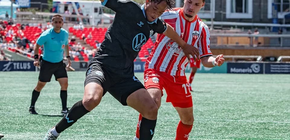HFX Wanderers FC player tackling Atlético Ottawa player