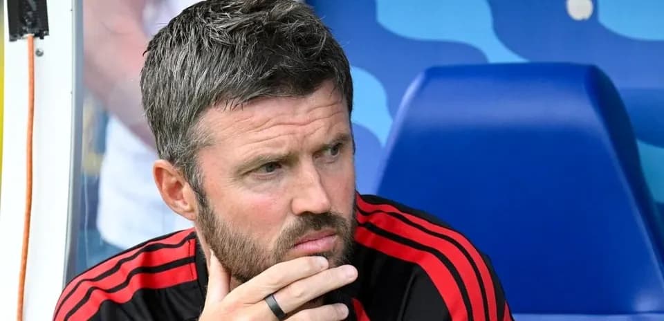 Coach deep in thought on the bench during match