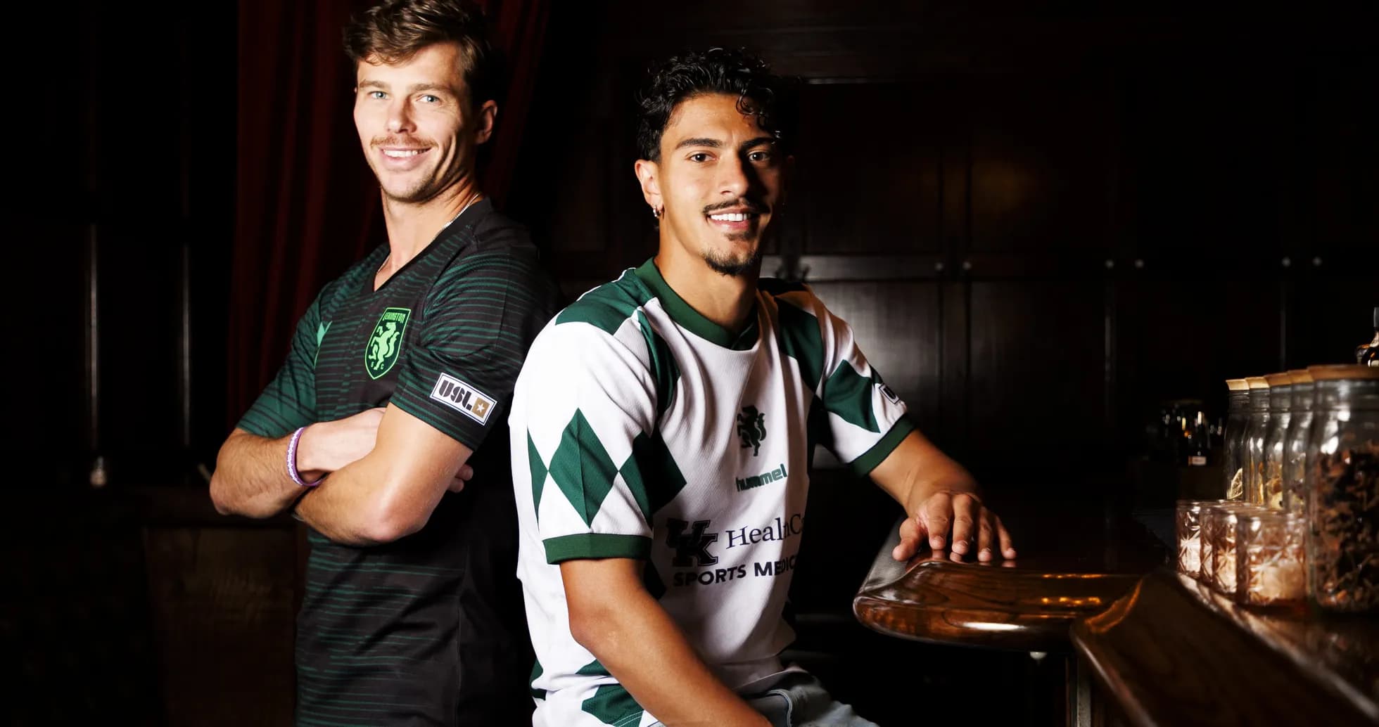Two players posing in team jerseys