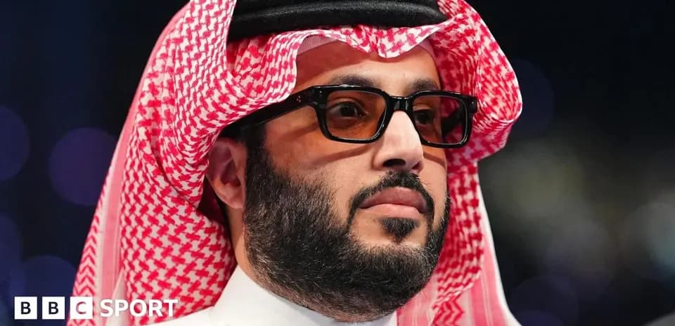 Man in traditional attire wearing glasses at event