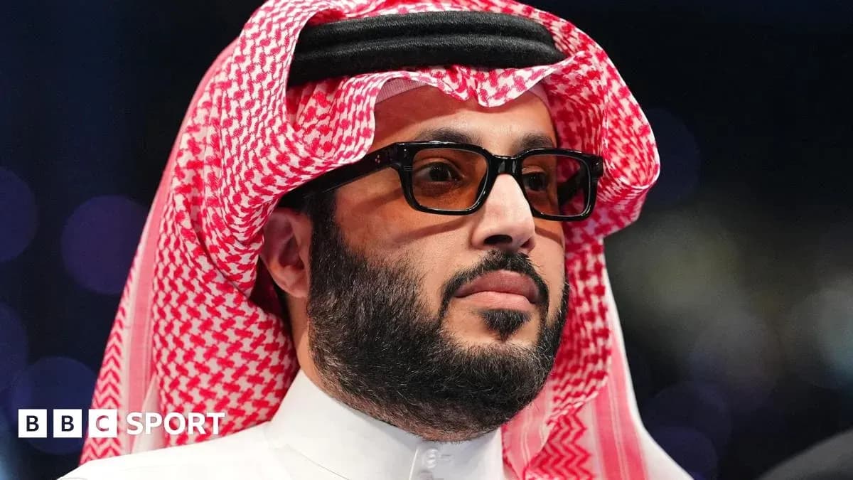 Man in traditional attire wearing glasses at event