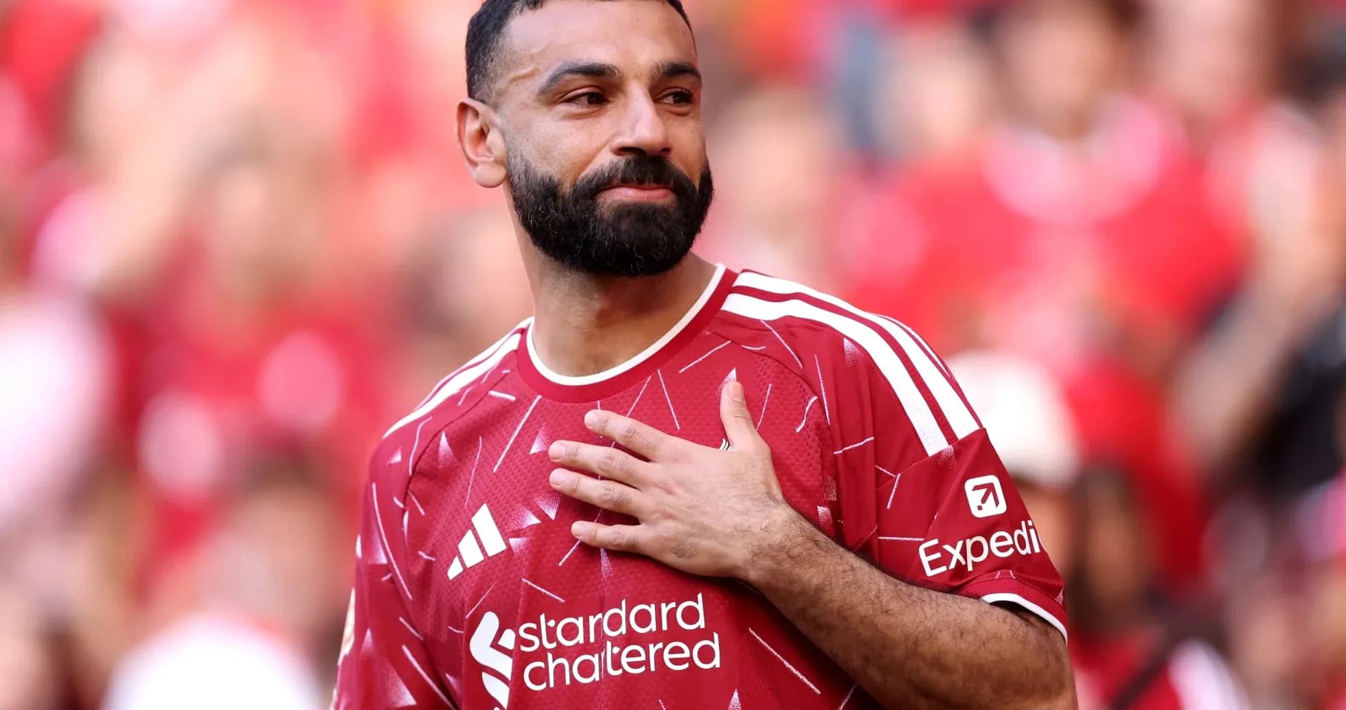 Player in red jersey with hand on chest