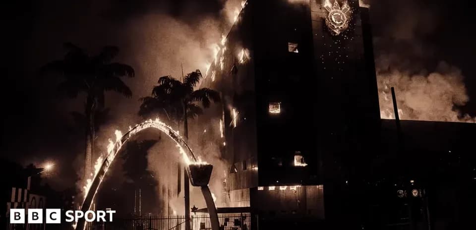 Building engulfed in flames with smoke rising