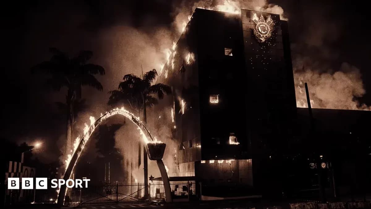 Building engulfed in flames with smoke rising