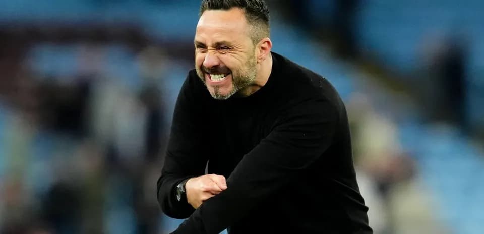 Coach celebrating enthusiastically on the sidelines