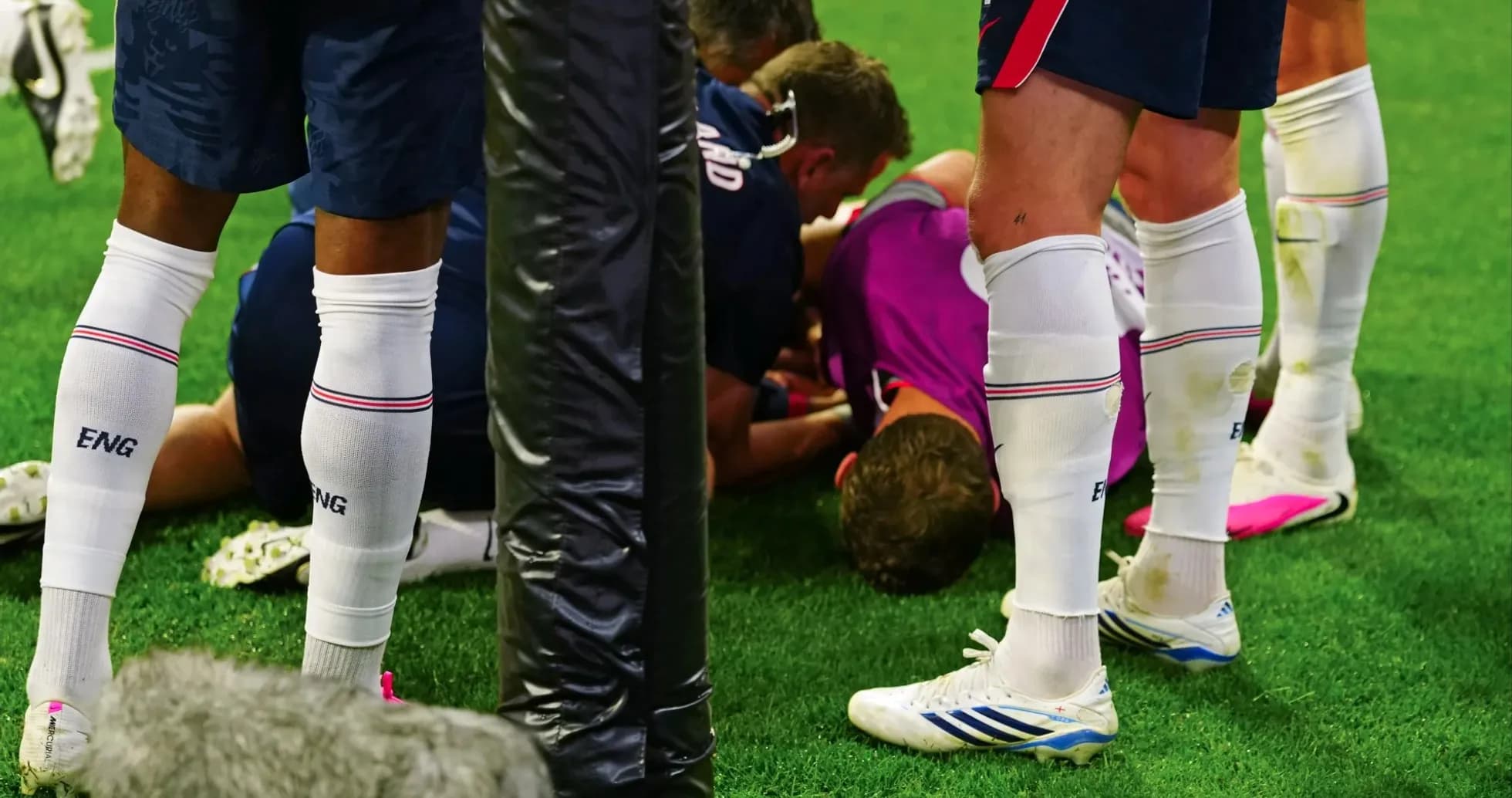 Players attending to an injured teammate on field