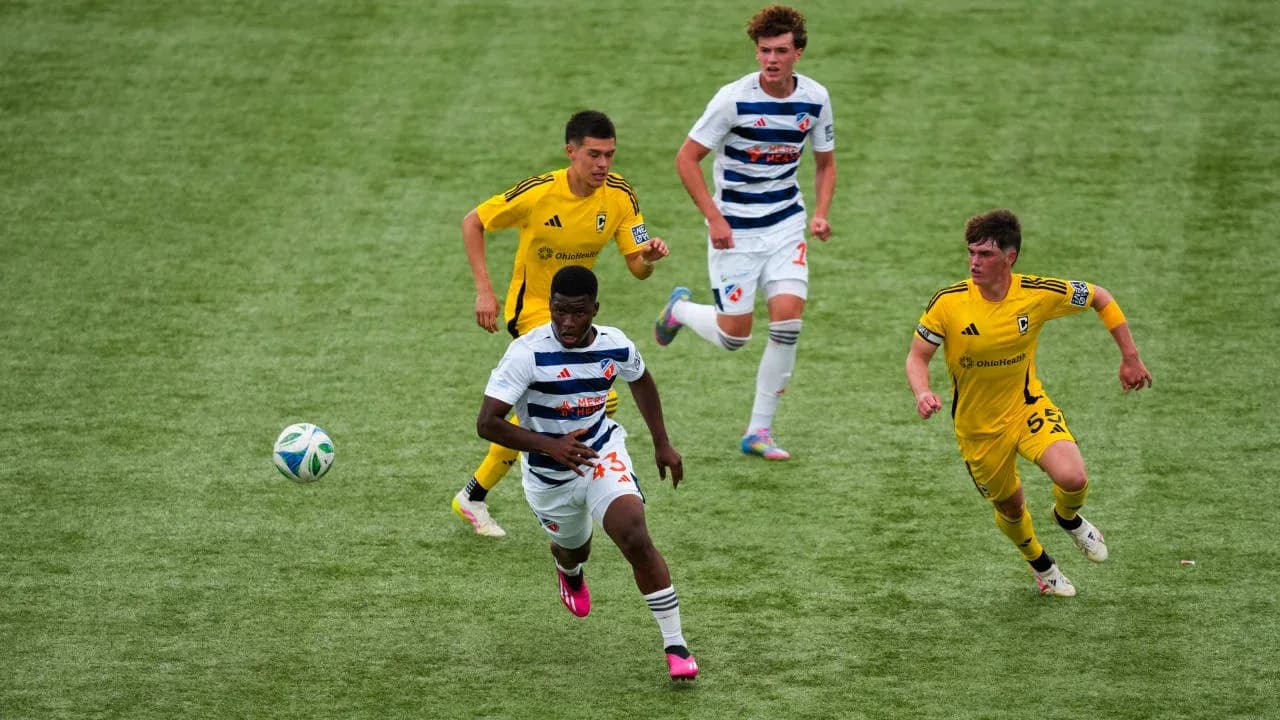 Players competing for the ball in football match
