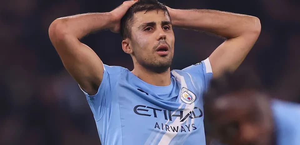 Player in light blue jersey holding head in distress