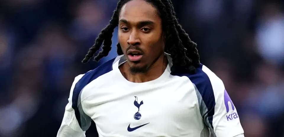 Player running during a match in Tottenham kit