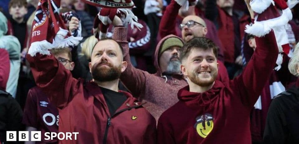 Fans celebrating with scarves in the stands