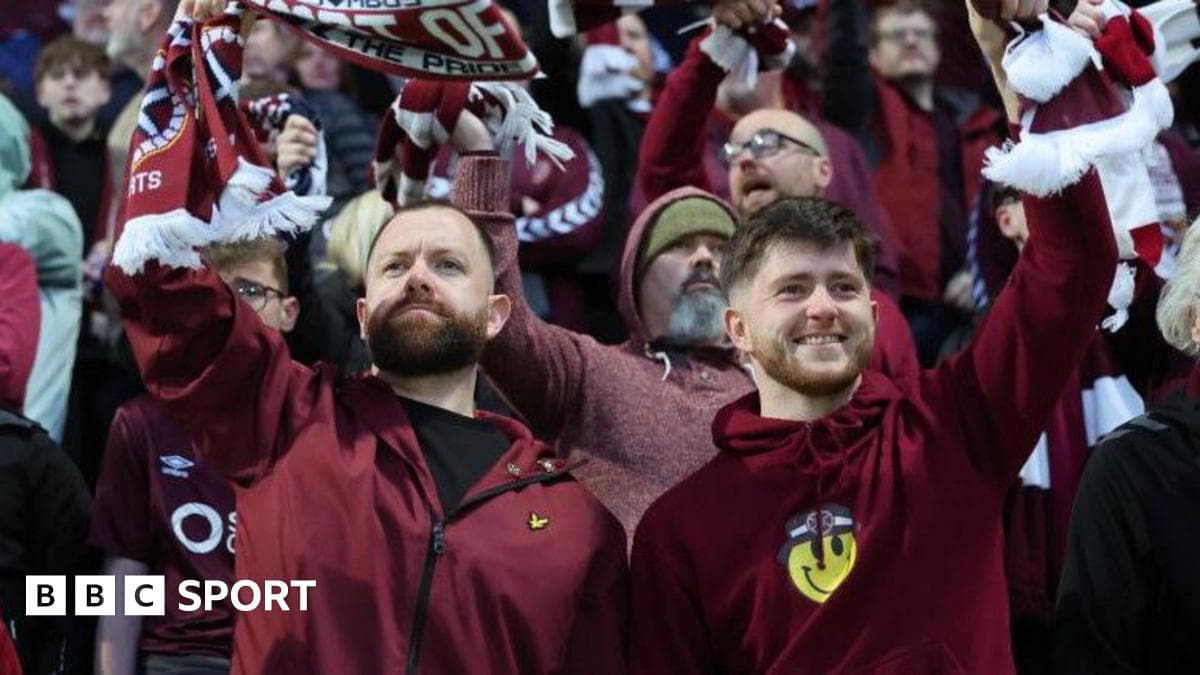 Fans celebrating with scarves in the stands