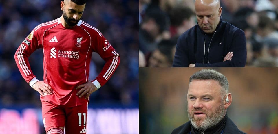 Liverpool player looking down; coaches observing match