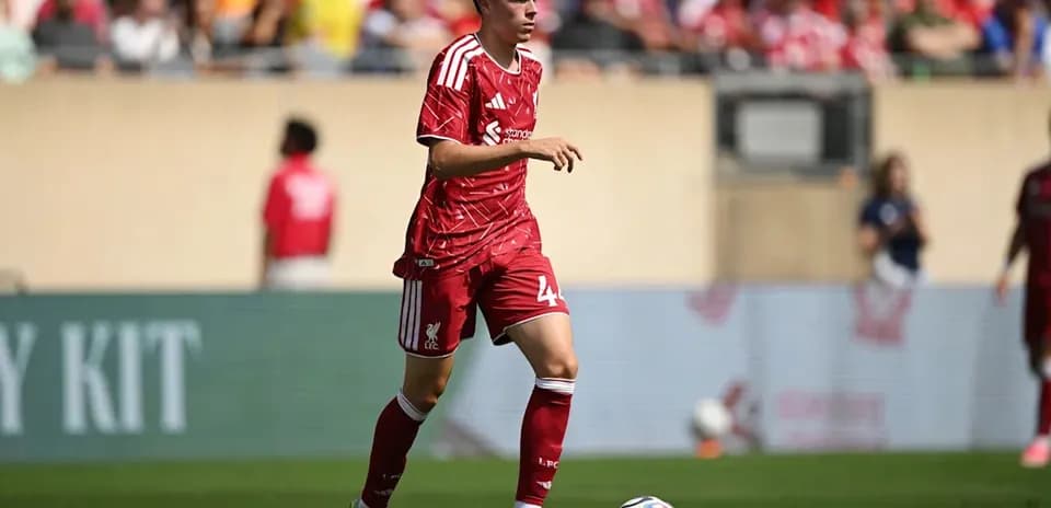 Liverpool player running with ball during match