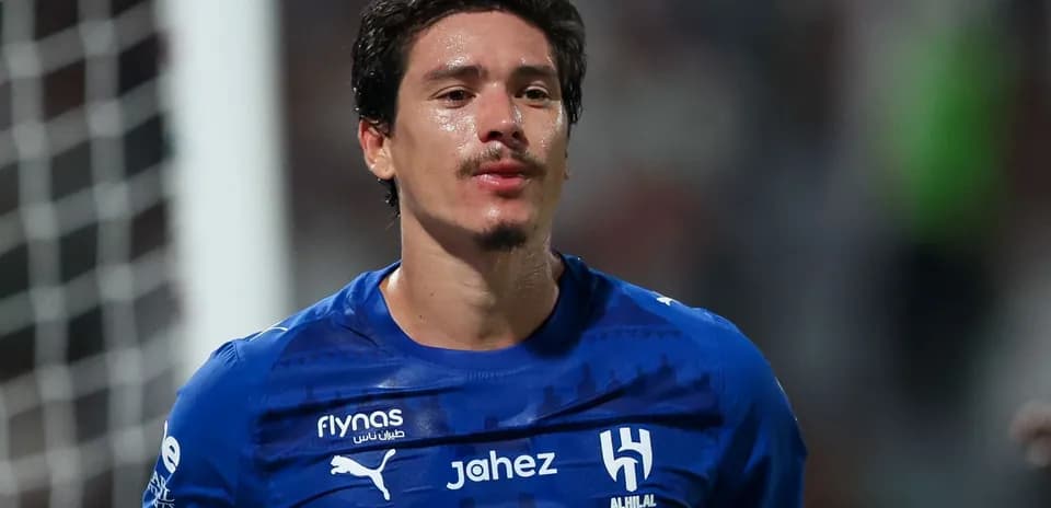 Player wearing blue jersey during match celebration
