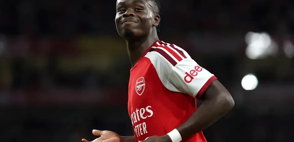 Player celebrating in Arsenal jersey during match