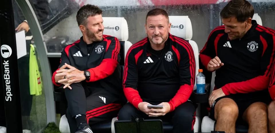 Coaching staff seated on the bench during match