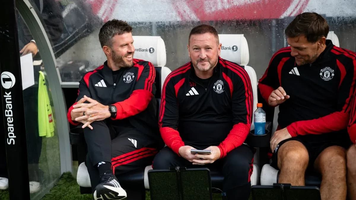 Coaching staff seated on the bench during match