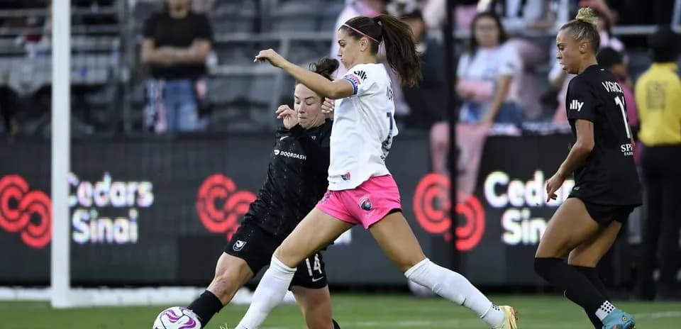 Angel City player challenging for the ball