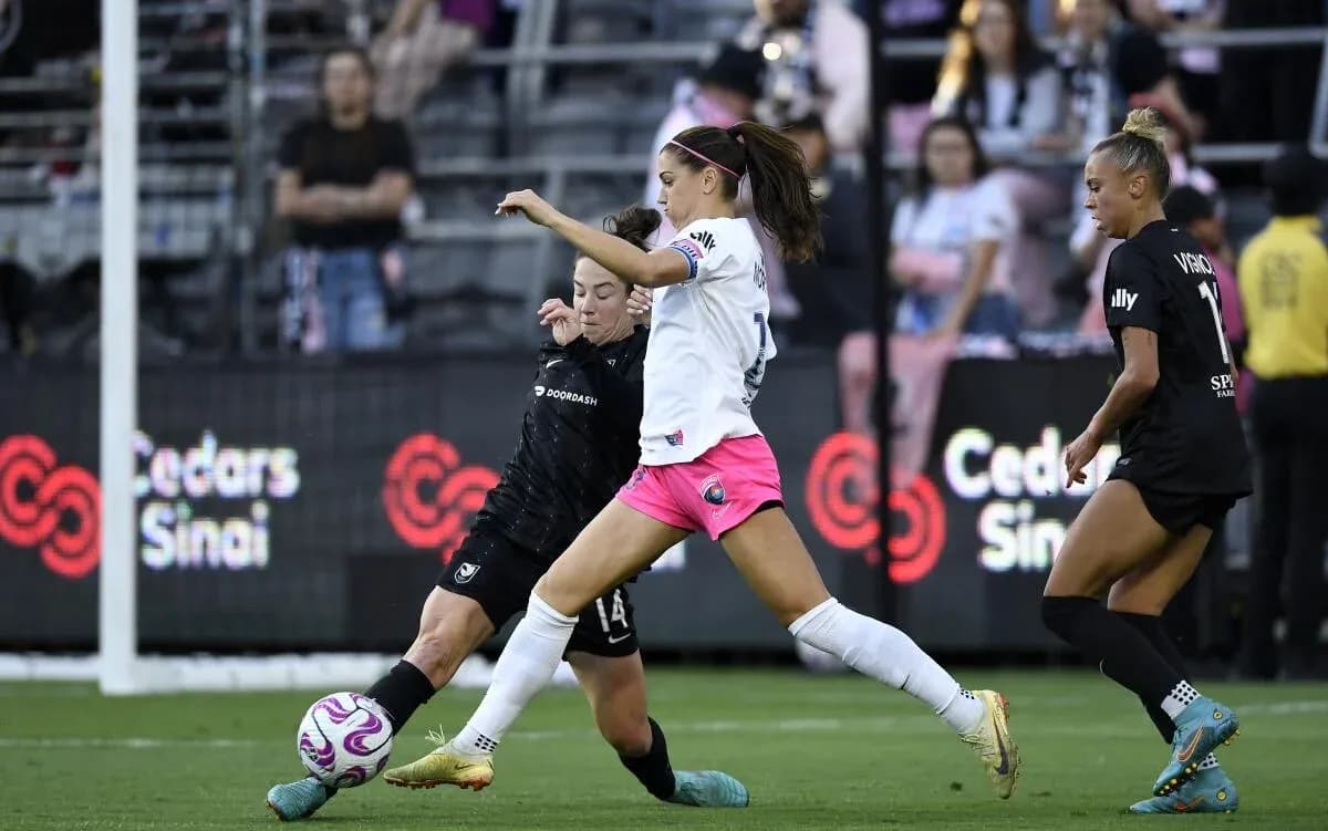 Angel City player challenging for the ball