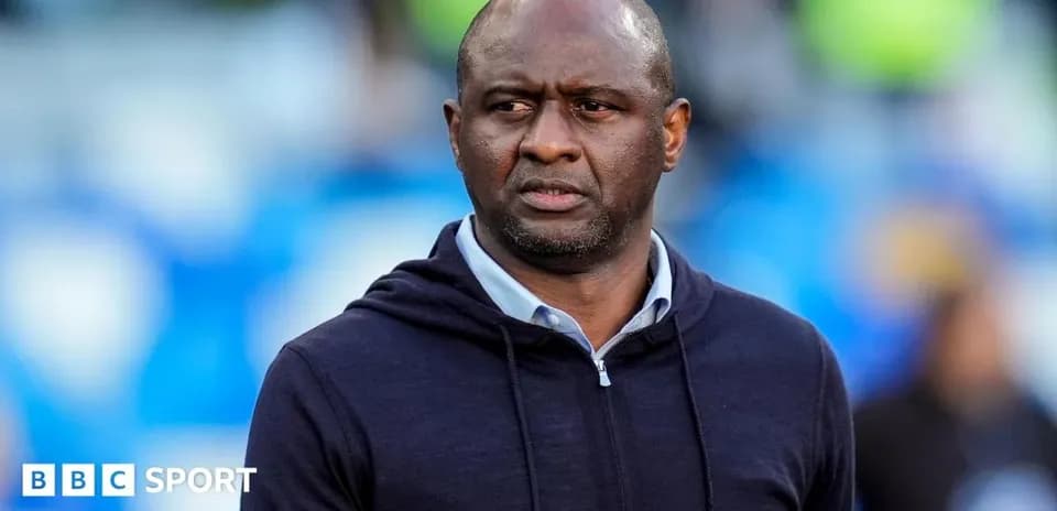 Coach observing from the sidelines during match