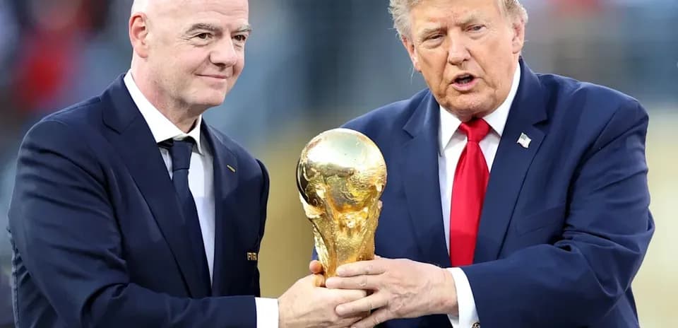 Gianni Infantino and Donald Trump holding World Cup trophy