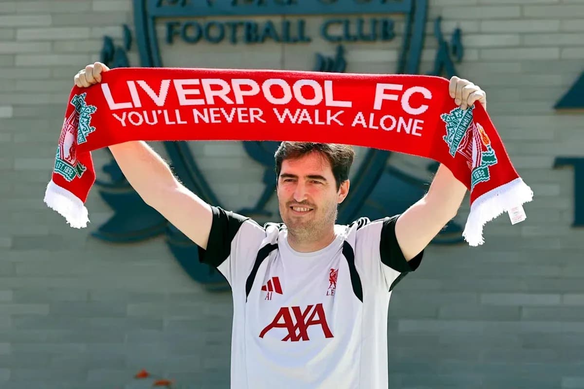 Person holding Liverpool FC scarf outside club