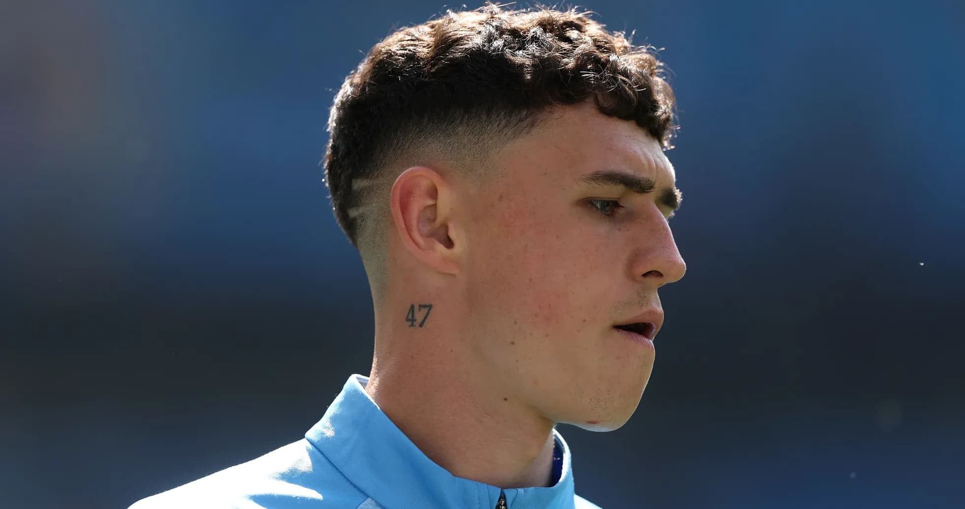 Player with short hair and tattoo during warm-up