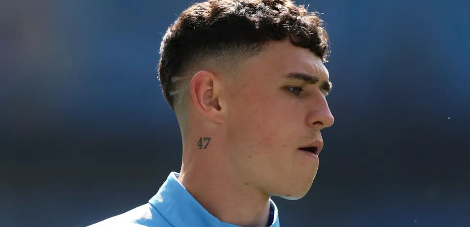 Player with short hair and tattoo during warm-up