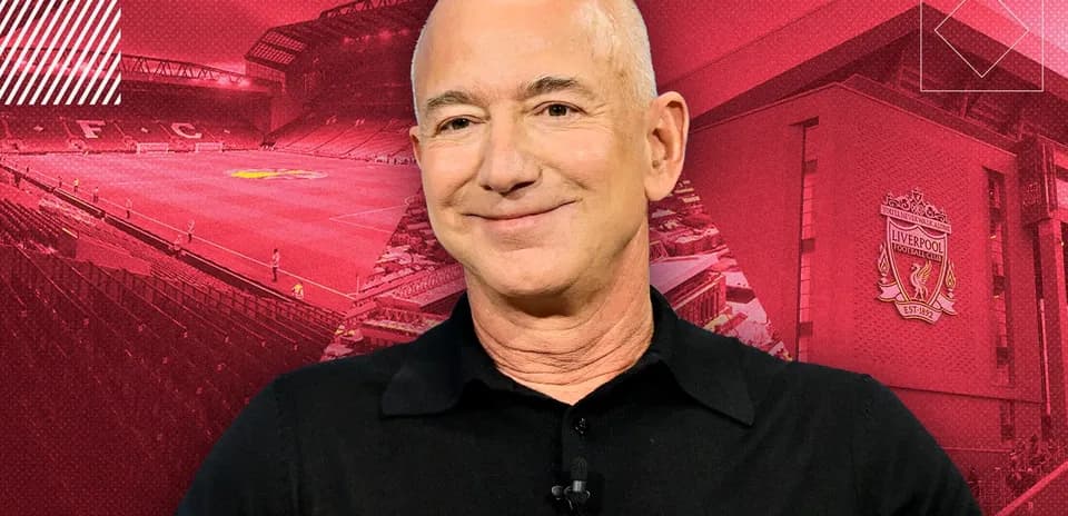 Person smiling with Liverpool FC stadium background