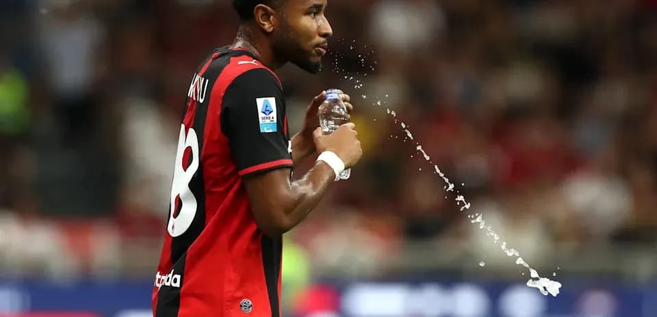 Player spraying water while holding a bottle