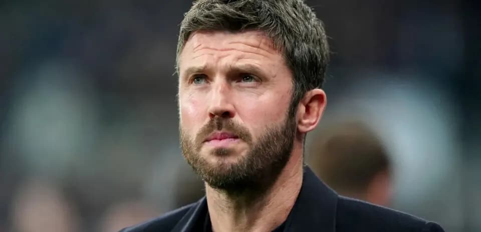 Man with short hair and beard looking thoughtfully