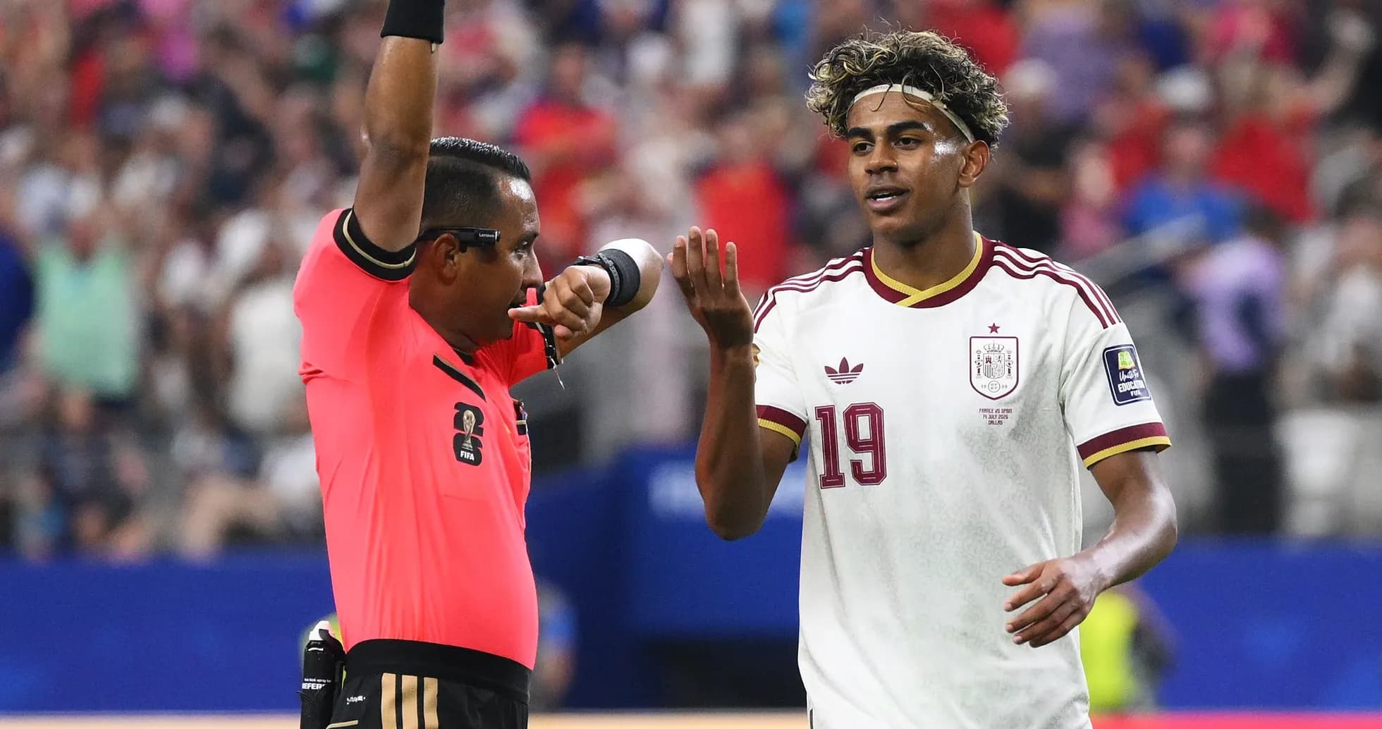 Referee issuing a warning to player during match