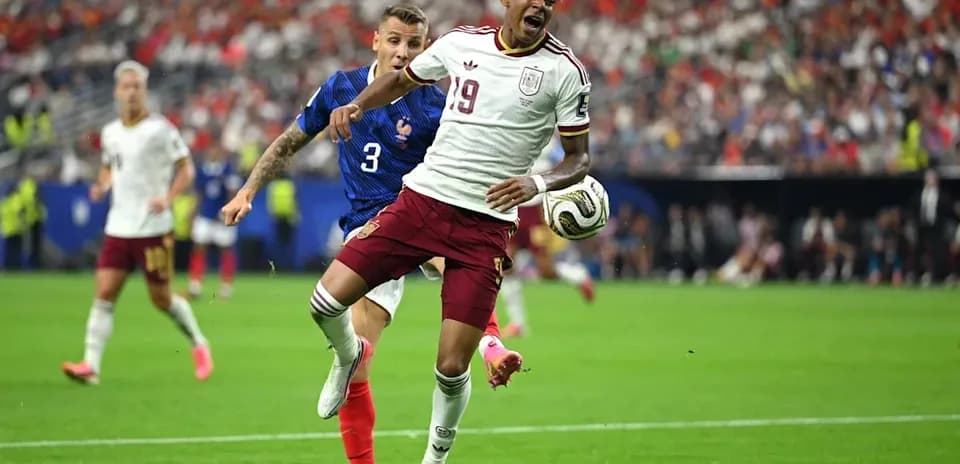 Player 19 from Spain being challenged by French defender