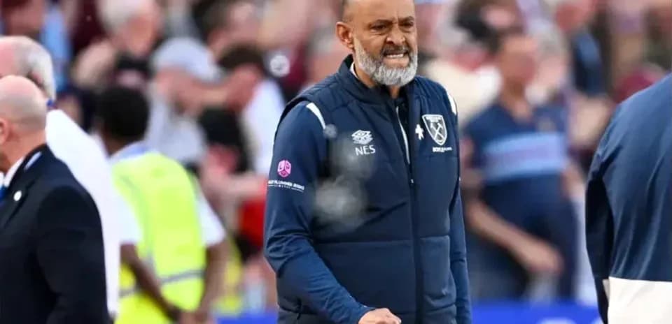 Manager celebrating during match with fans in background