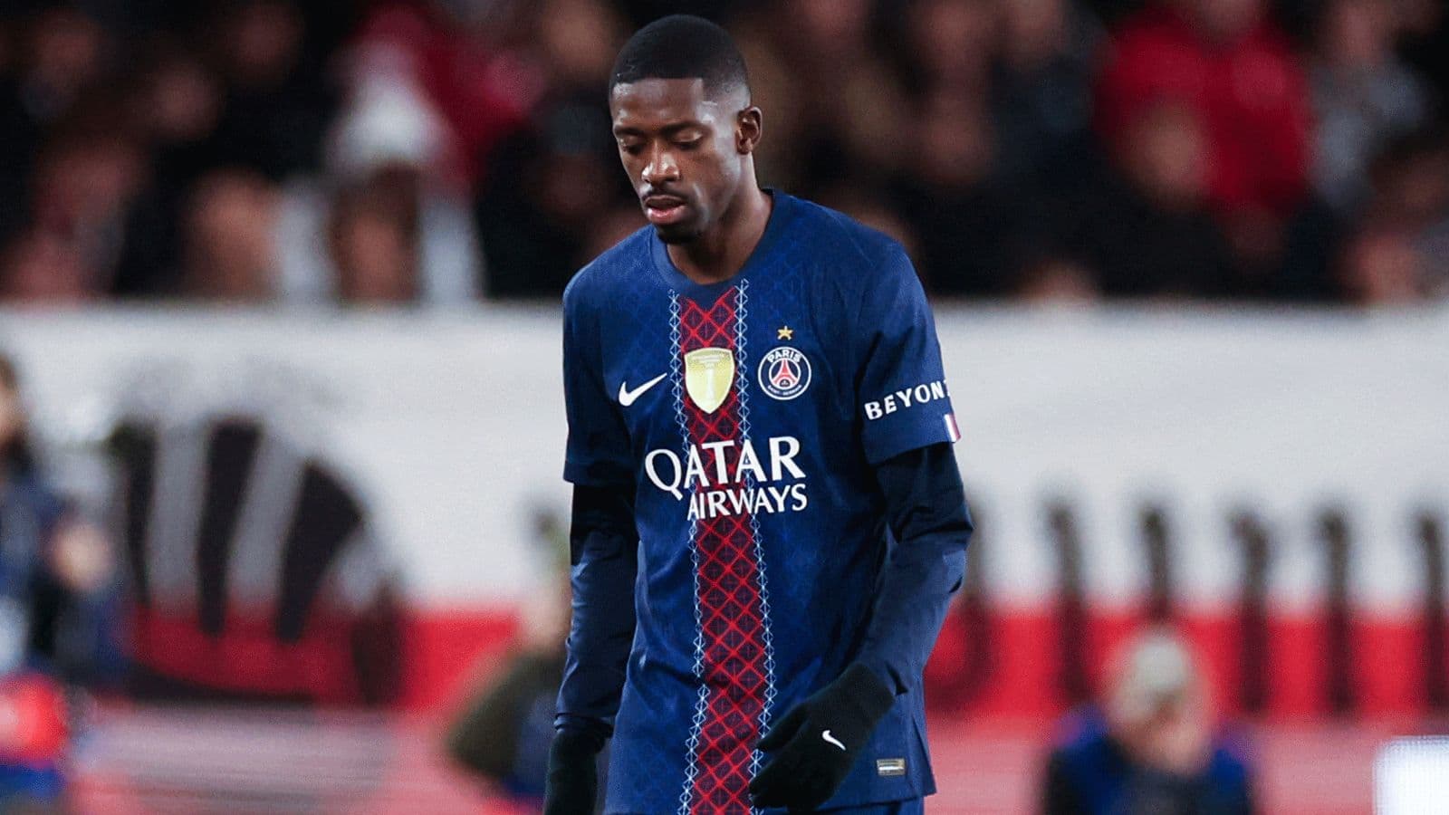 Player in PSG jersey walking on the pitch