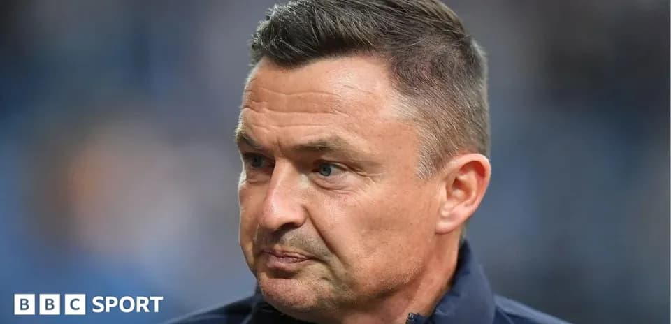 Coach during a match, focused expression
